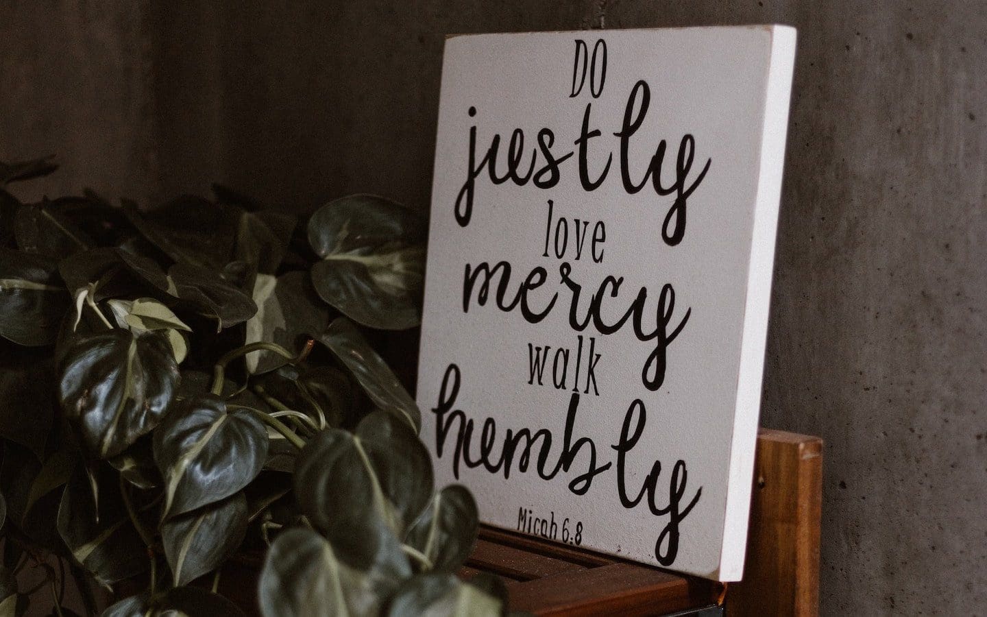 A painted sign displaying the words of Micah 6:8: “Do justly