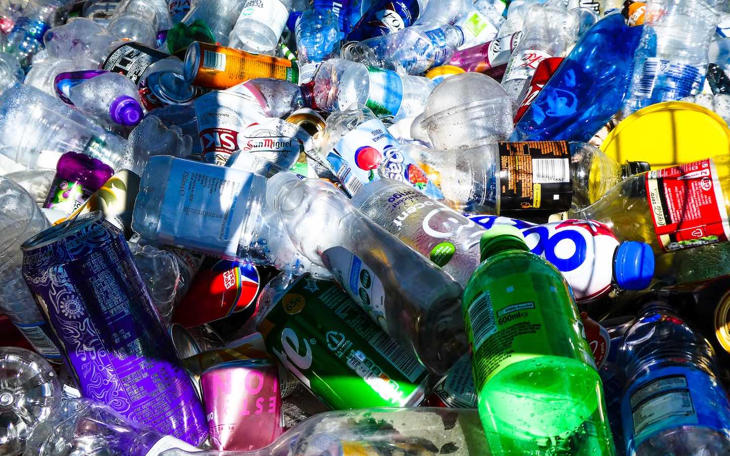 A close-up image of a large pile of plastics and cans.