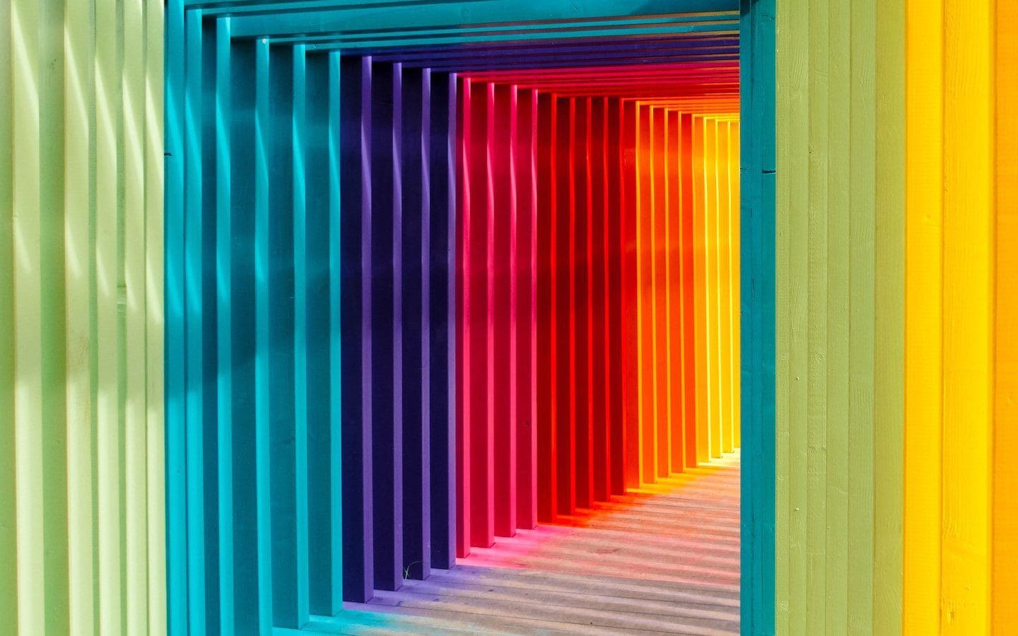 A walkway that is painted in rainbow colors.