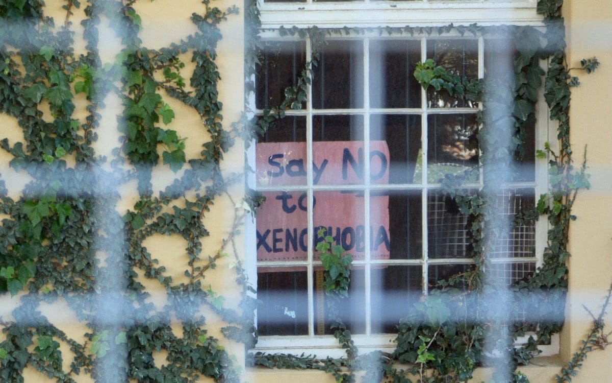 A sign in a window that says