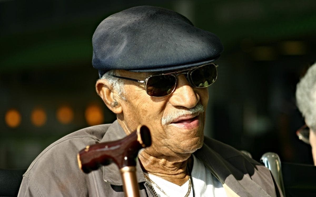 Older male with sunglasses and cane