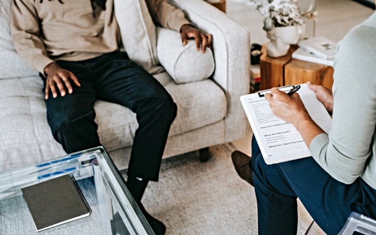 Man on couch talking to therapist