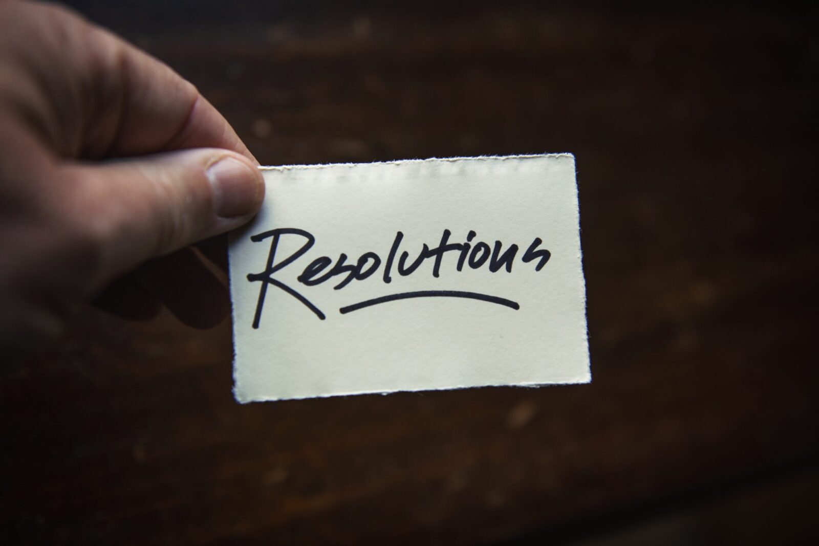 A man holding a card that reads