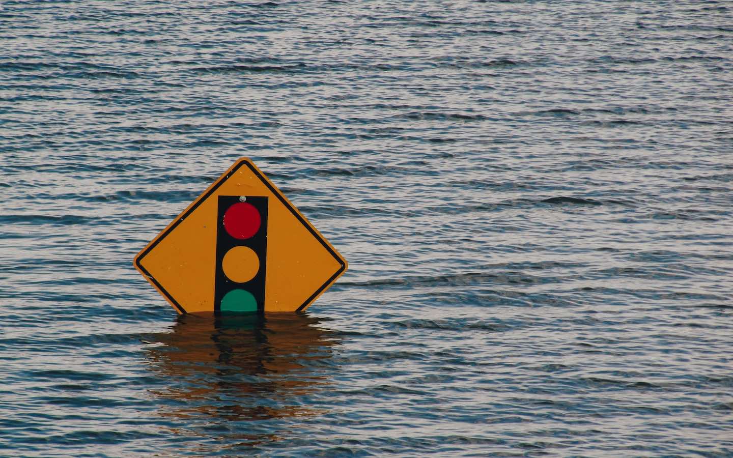 A traffic sign that is almost completely underwater.