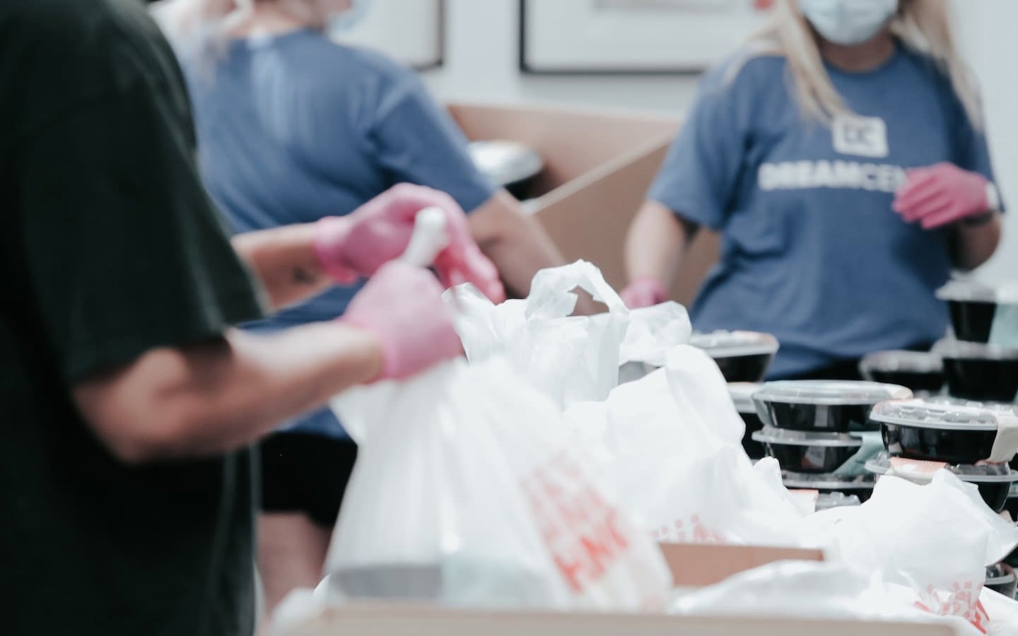 Volunteers packing bags of food for distribution.