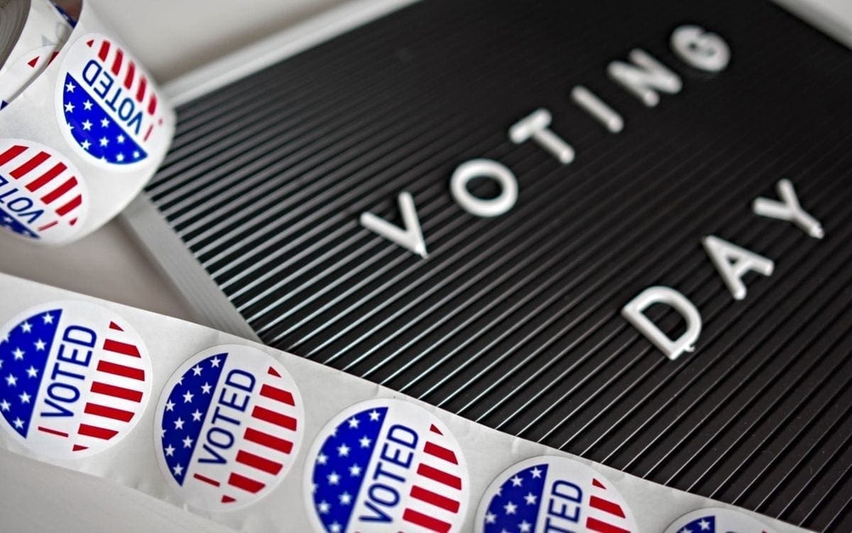 Voting stickers and board with Voting Day on it