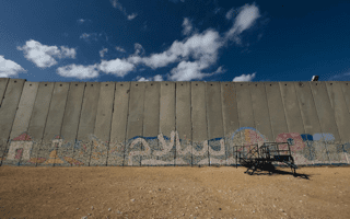 A wall in Gaza with graffiti on it.