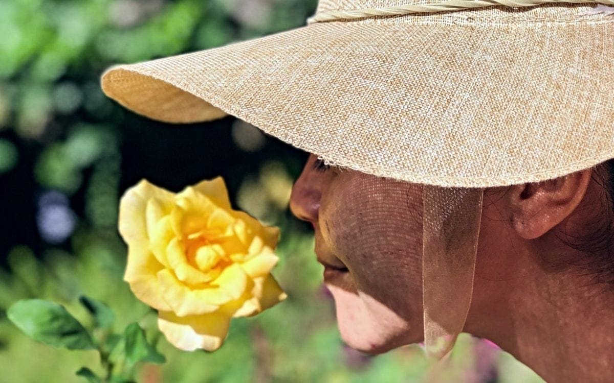 Woman smelling yellow rose