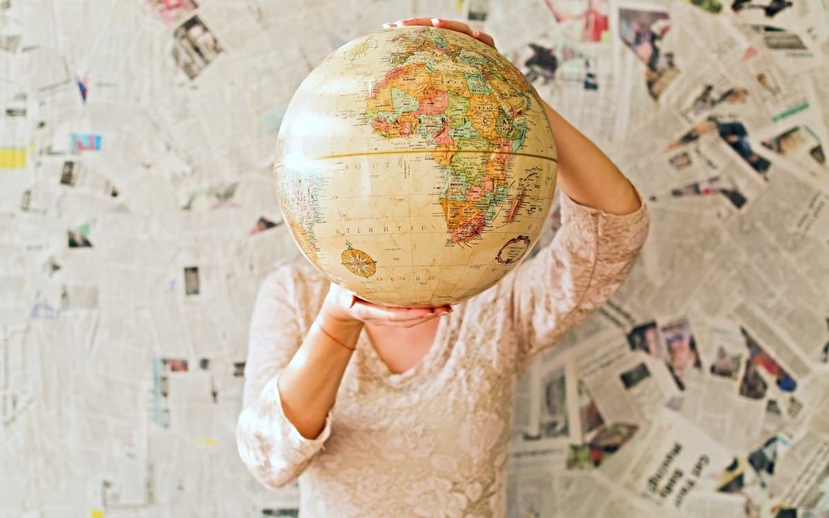 Woman holding up globe