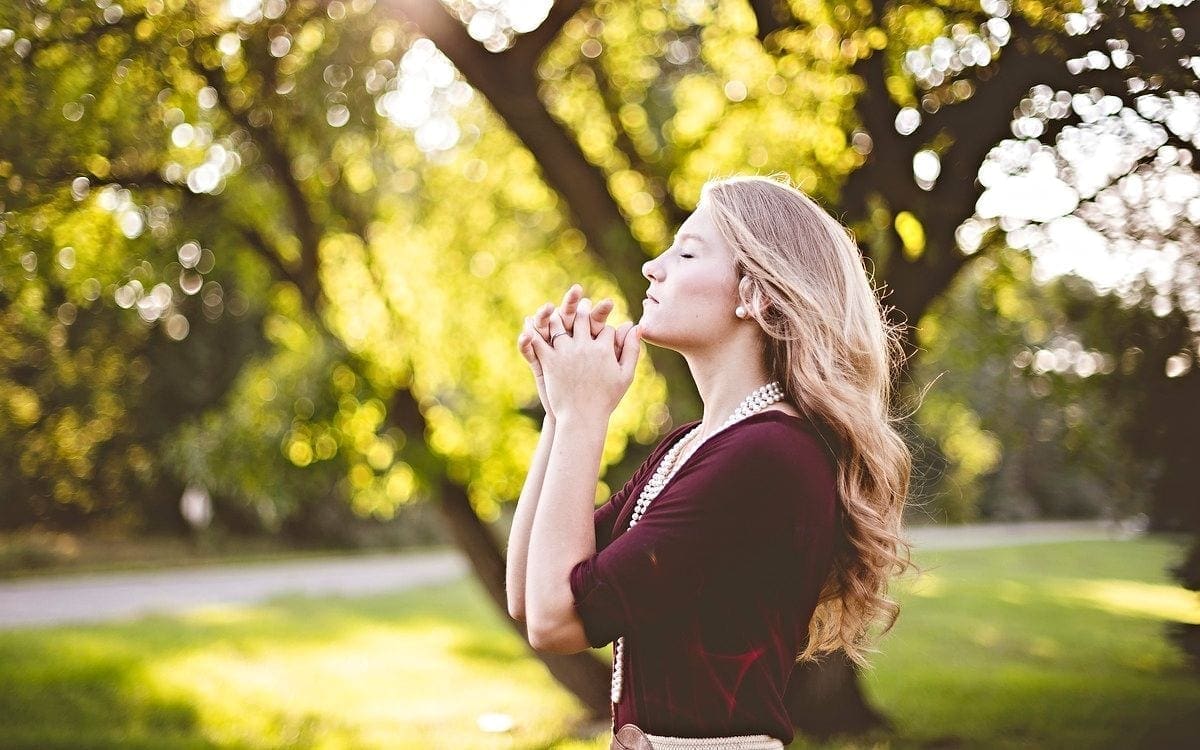Woman praying outdoors