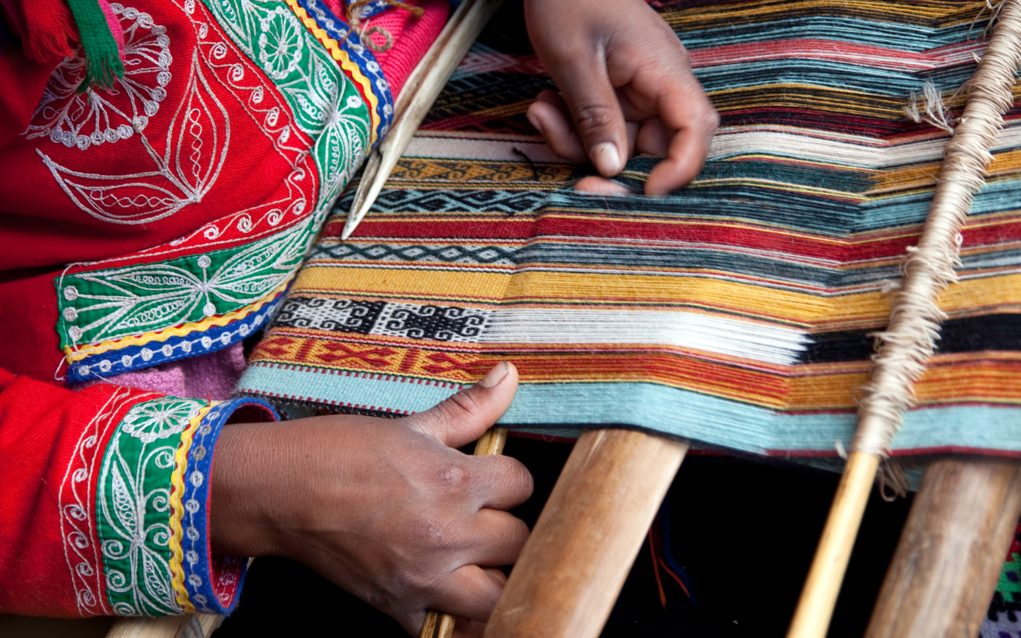 A Peruvian woman weaving an indigenous design.