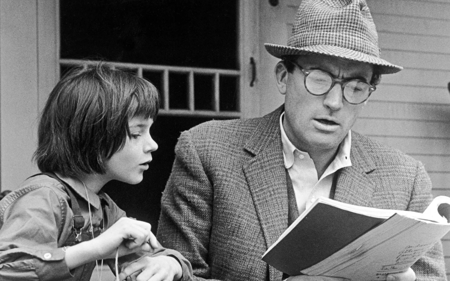 A still image of Scout and Atticus Finch in the film “To Kill a Mockingbird.”