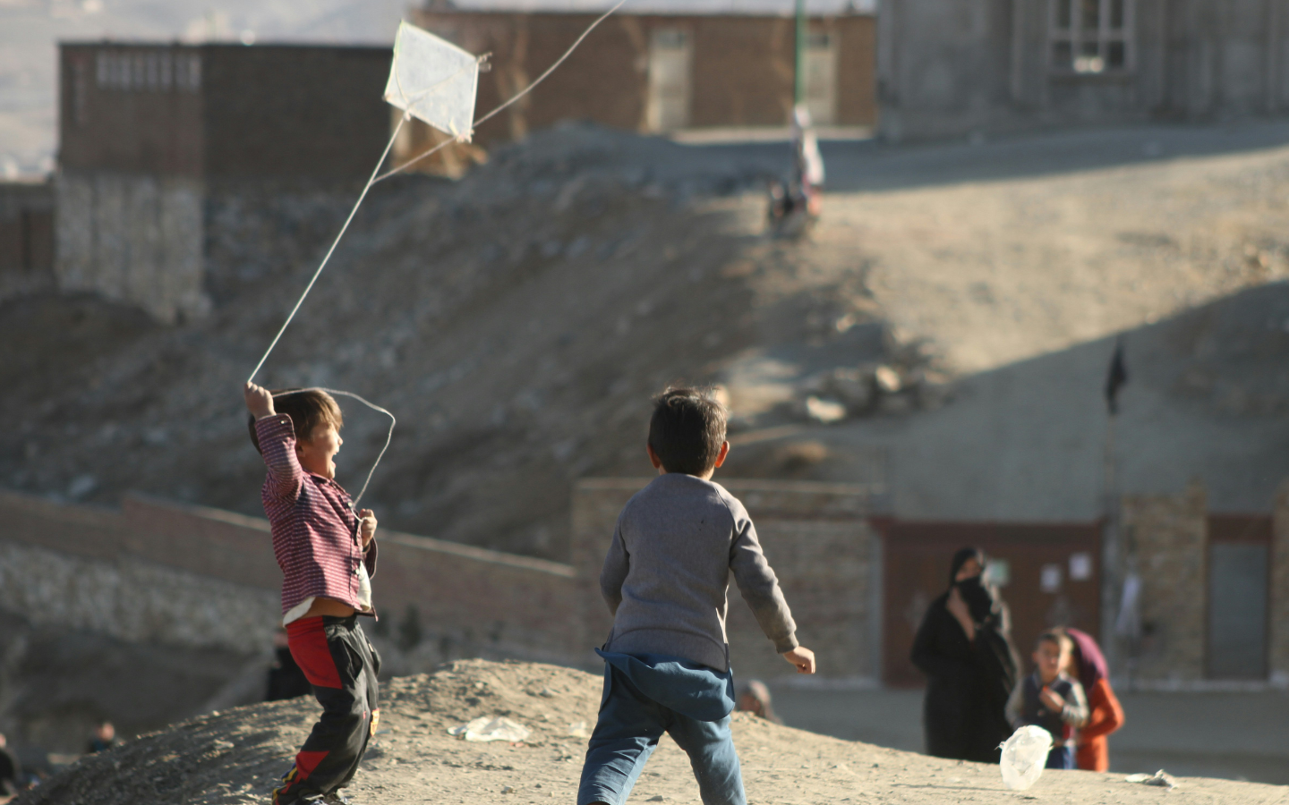 Afghan boys flying a kite.