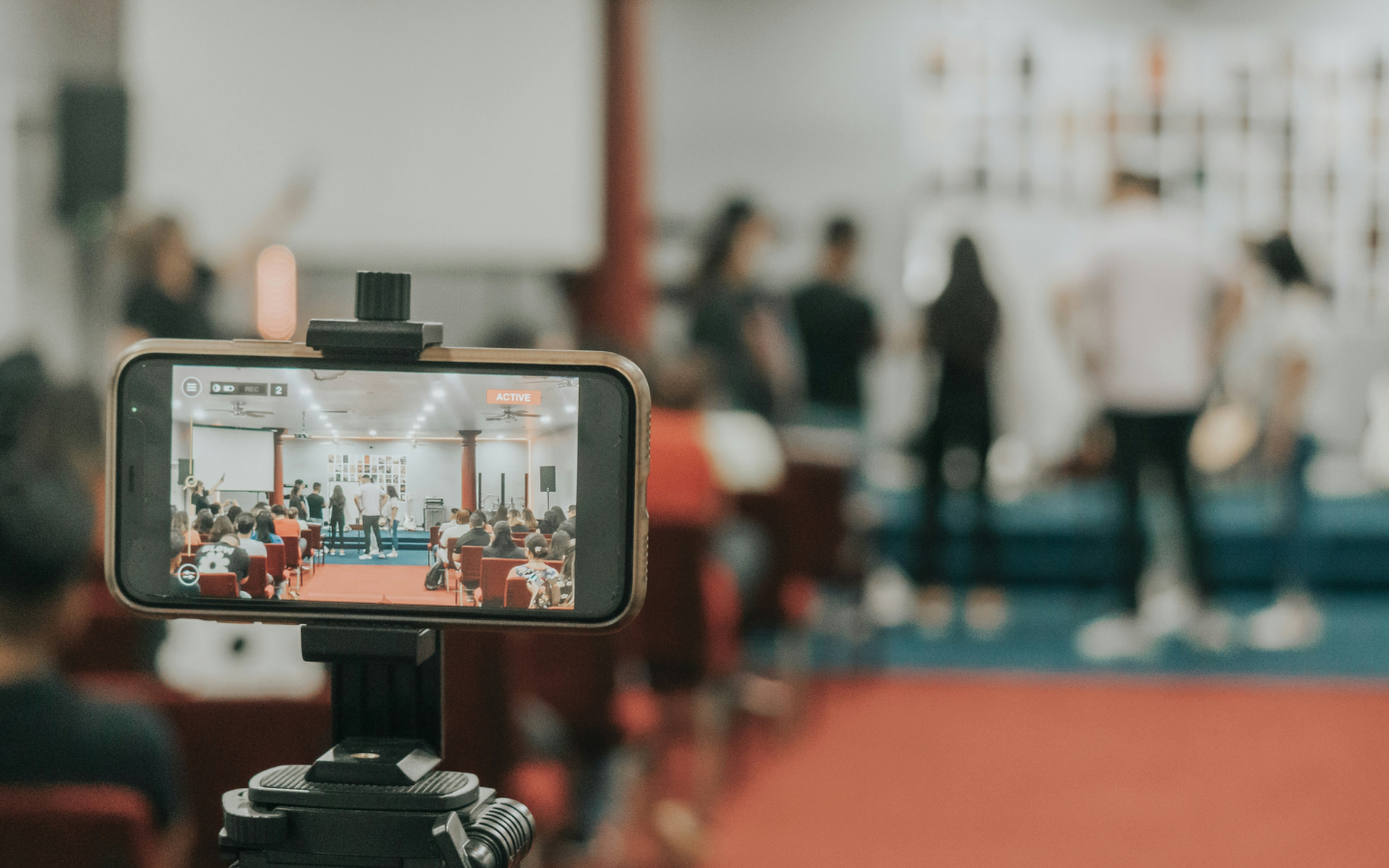An iPhone records a church service for livestreaming.