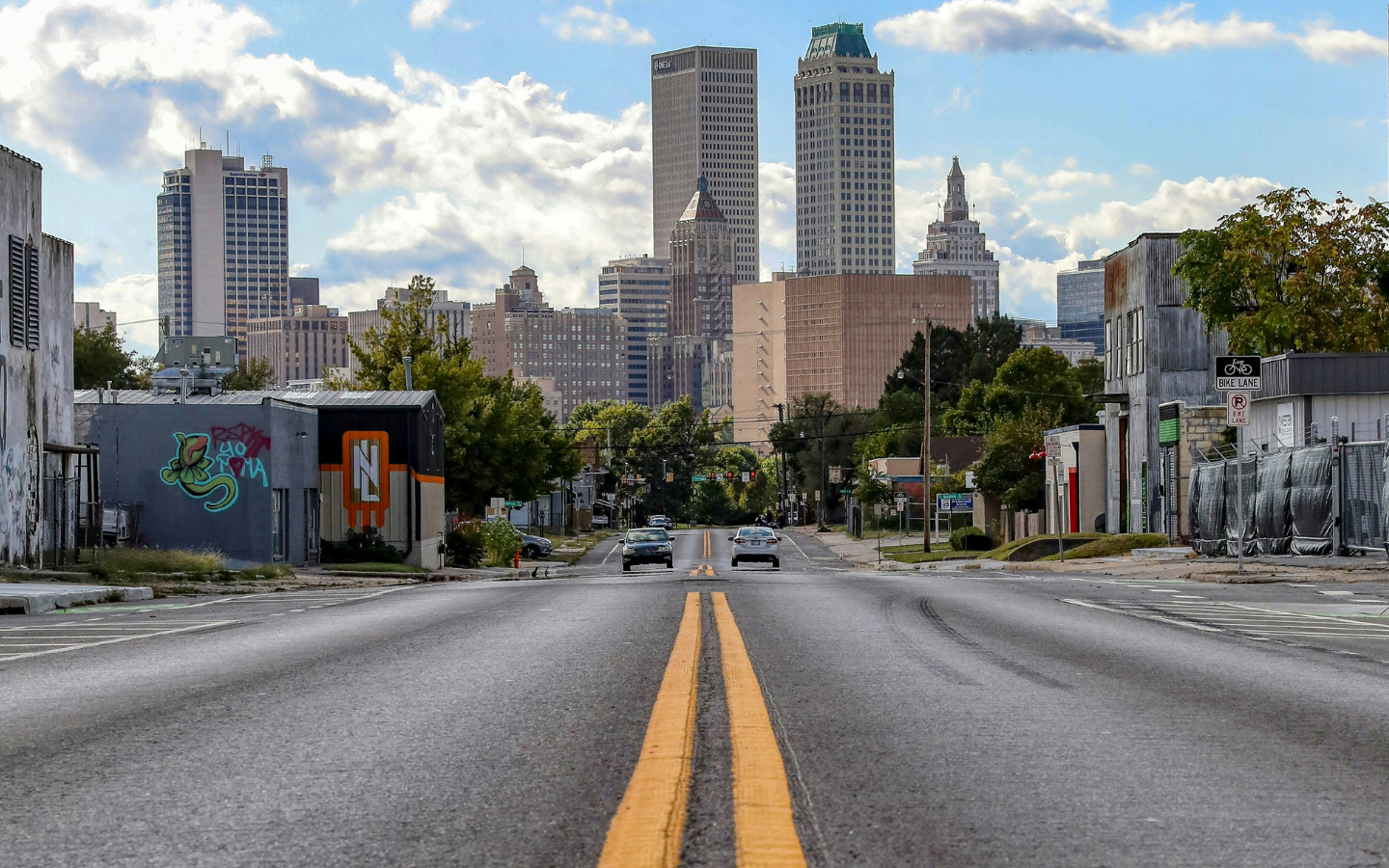 An image of a double yellow line on a street leading into Tulsa, Oklahoma.