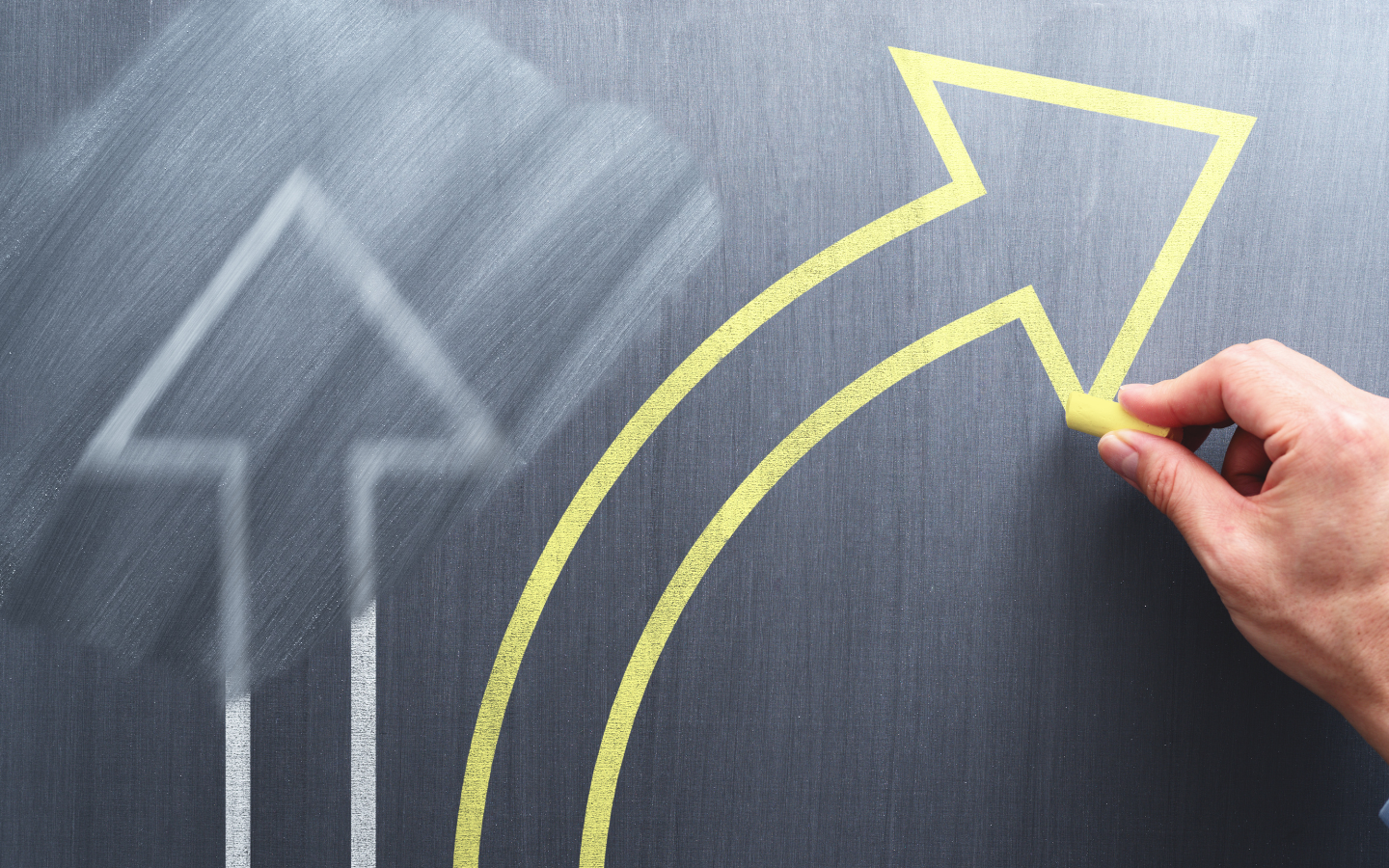 Two arrows on a chalkboard represent changing directions.