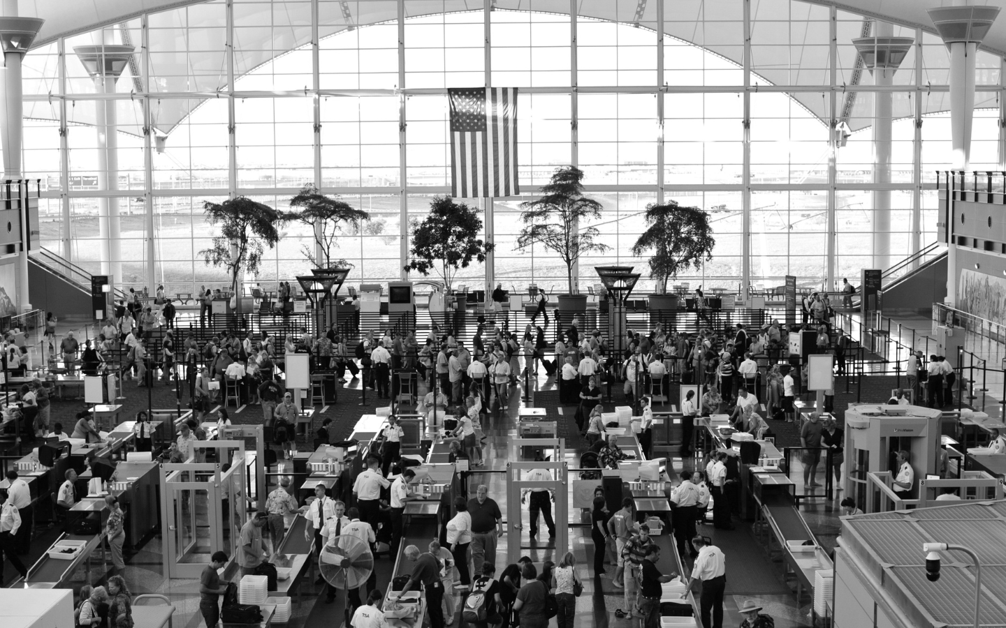 A black and white photo of the airport security lines at Denver International Airport.
