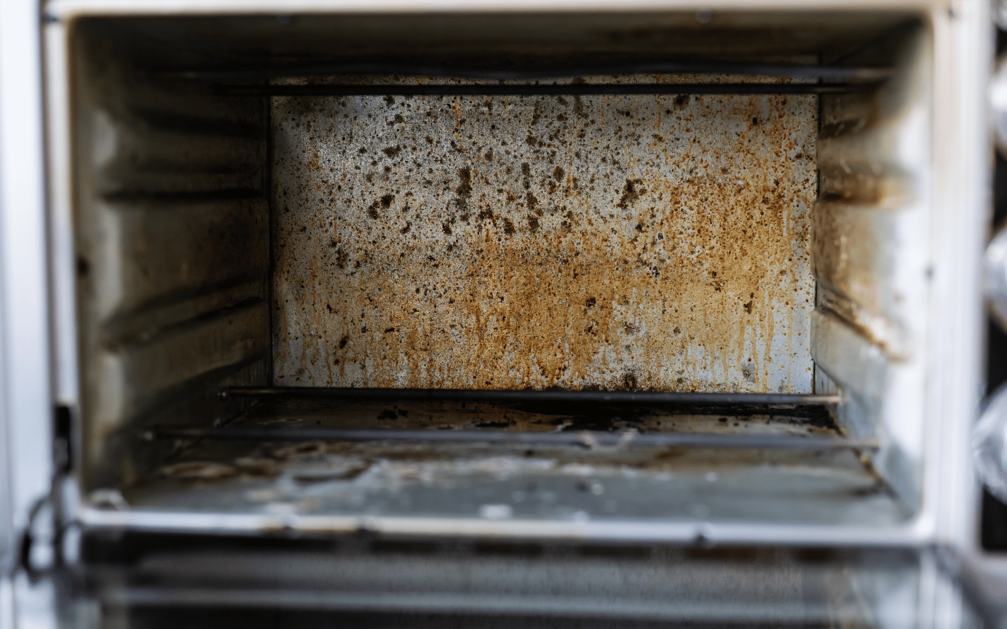 An old oven with lingering grease stains.