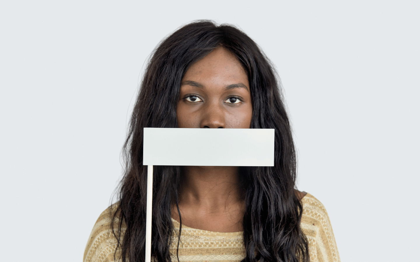A woman with a white covering over her mouth.