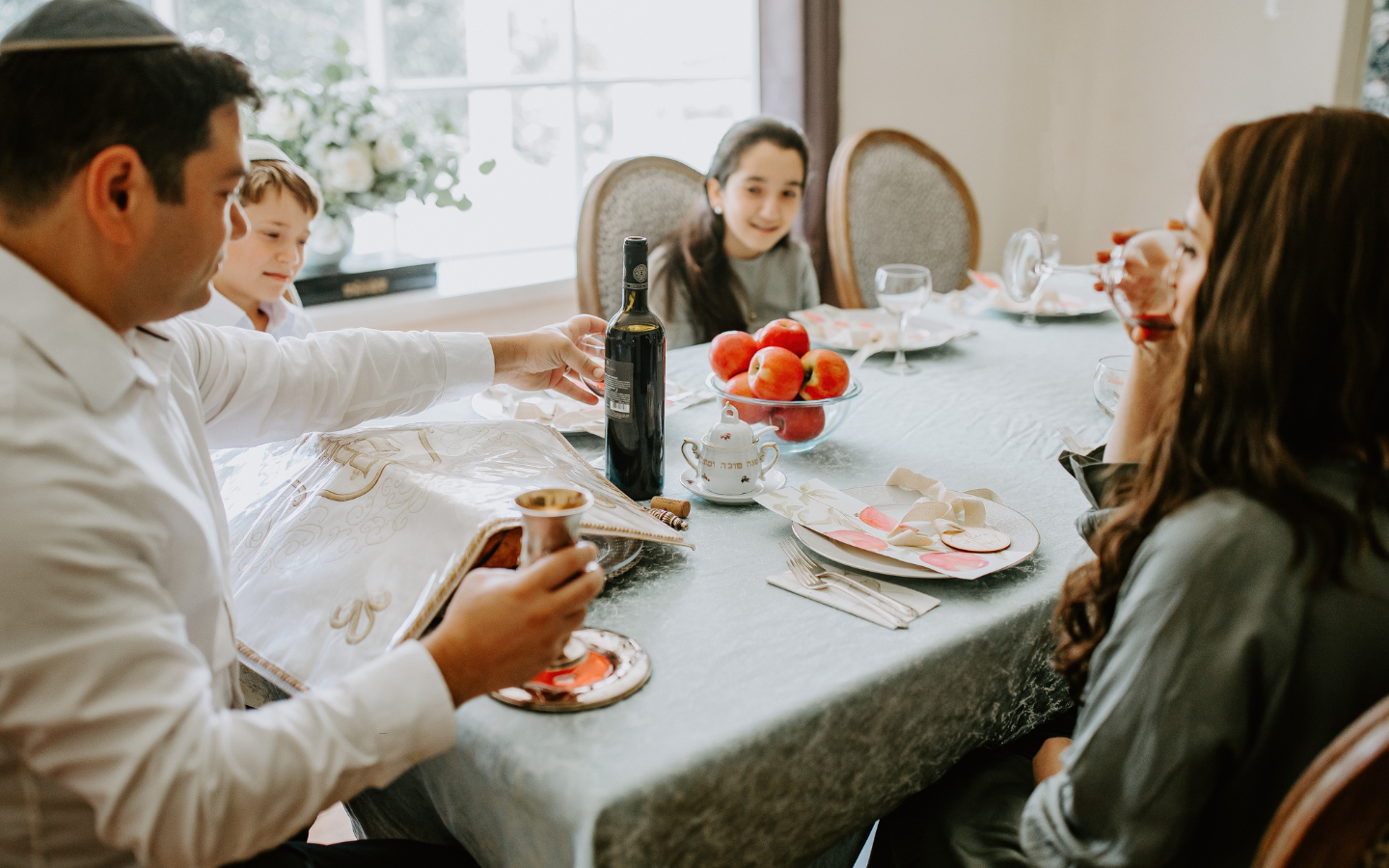A family eats a Rosh Hashanah meal.