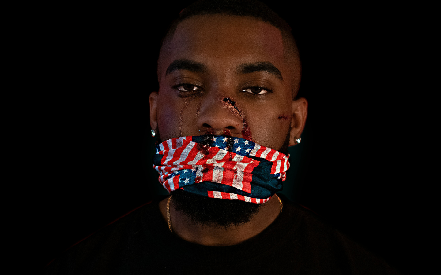 A man with U.S. flag-patterned tape covering his mouth, representing censorship.