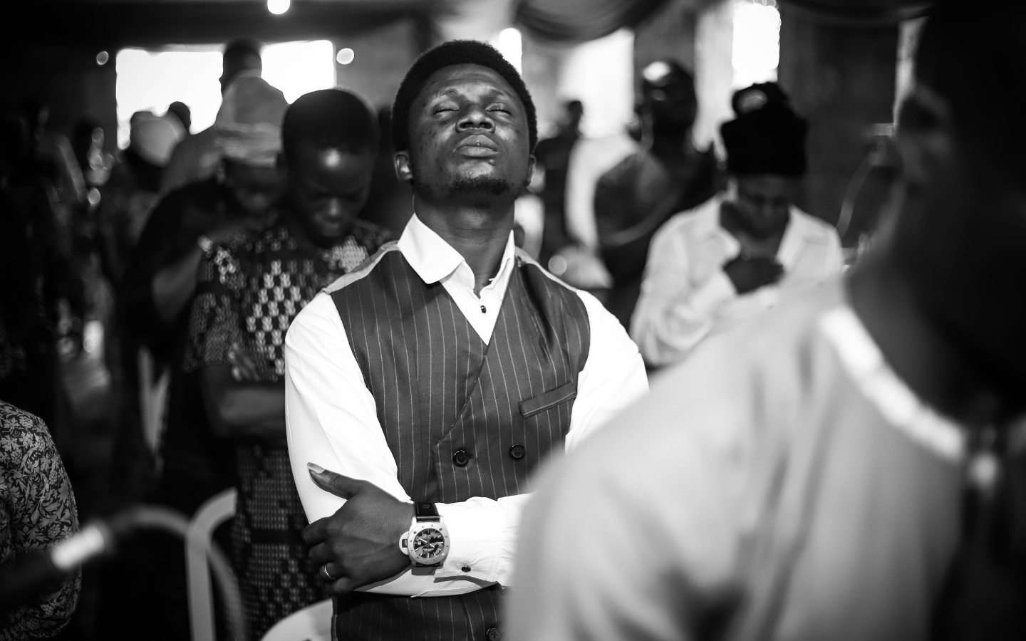 A photo of a man worshipping in a Nigerian church.