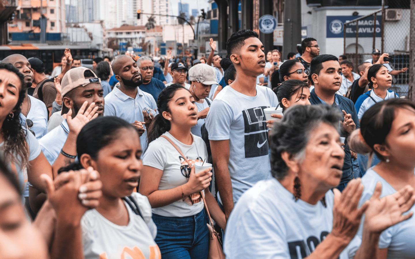 A crowd of organizers gathers on a city street during the daytime.