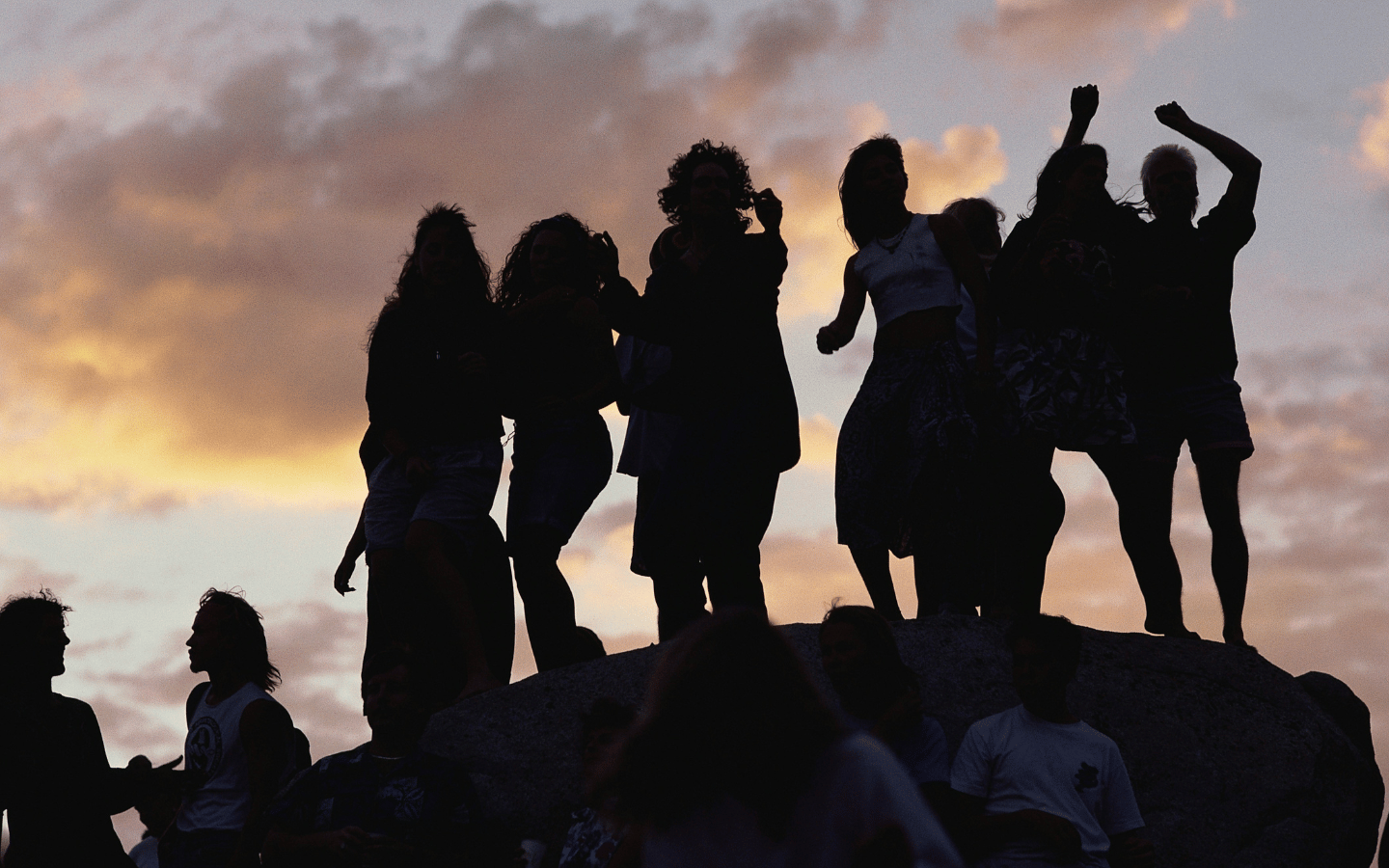 A silhouette of a group of women standing together.