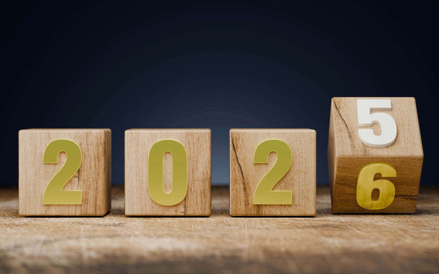 Wooden blocks transitioning from 2025 to 2026.