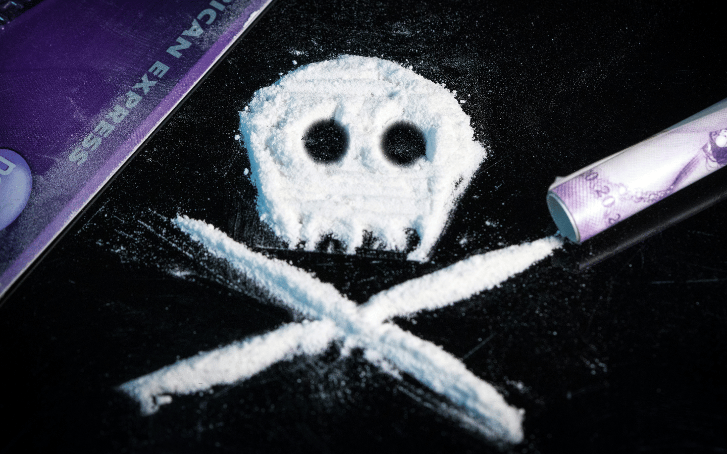Cocaine arranged in a pattern to mirror the skull-and-cross-bones image for poison.