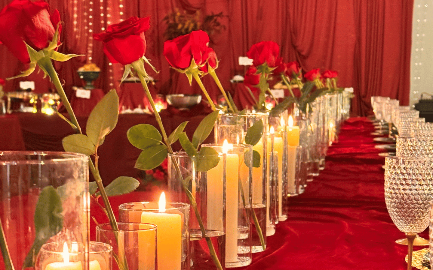 A row of candles and roses at the Madina Institute dinner.