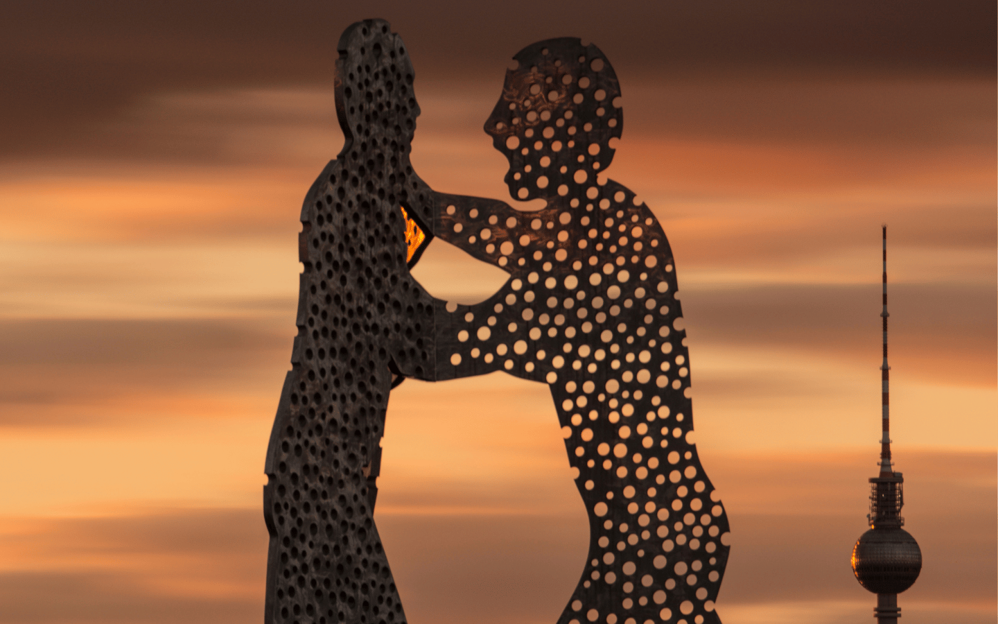 The Molecule Man statue in Berlin, depicts two men arguing with each other with holes in their bodies.