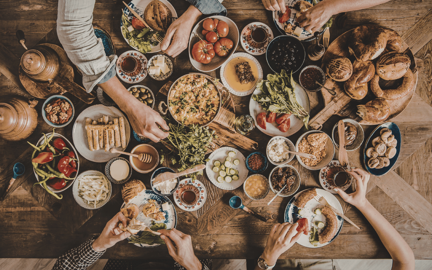 An aerial view of people at a table full of food.