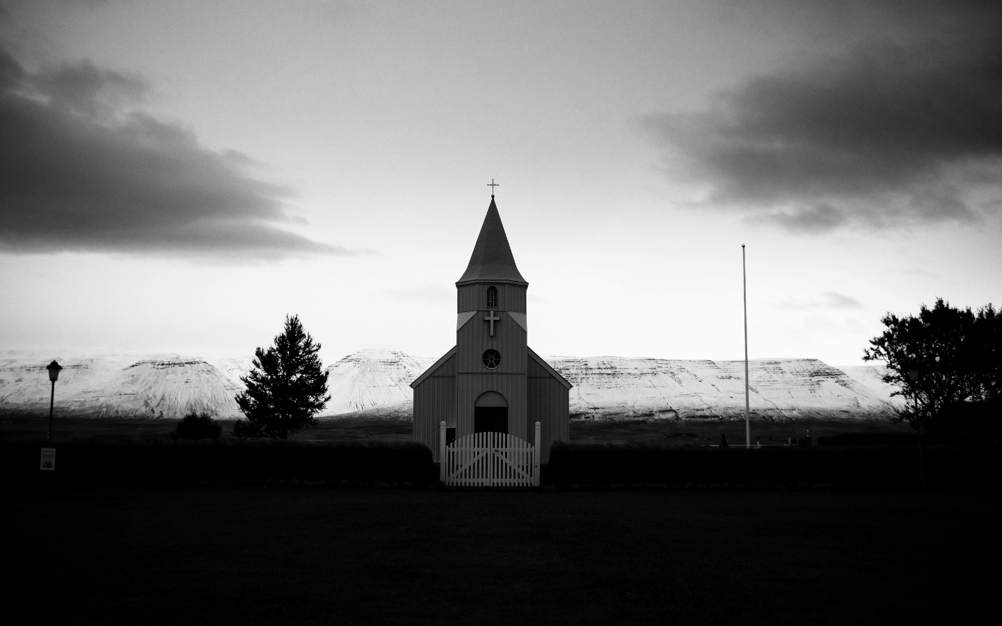 A shadowy country church at dawn.