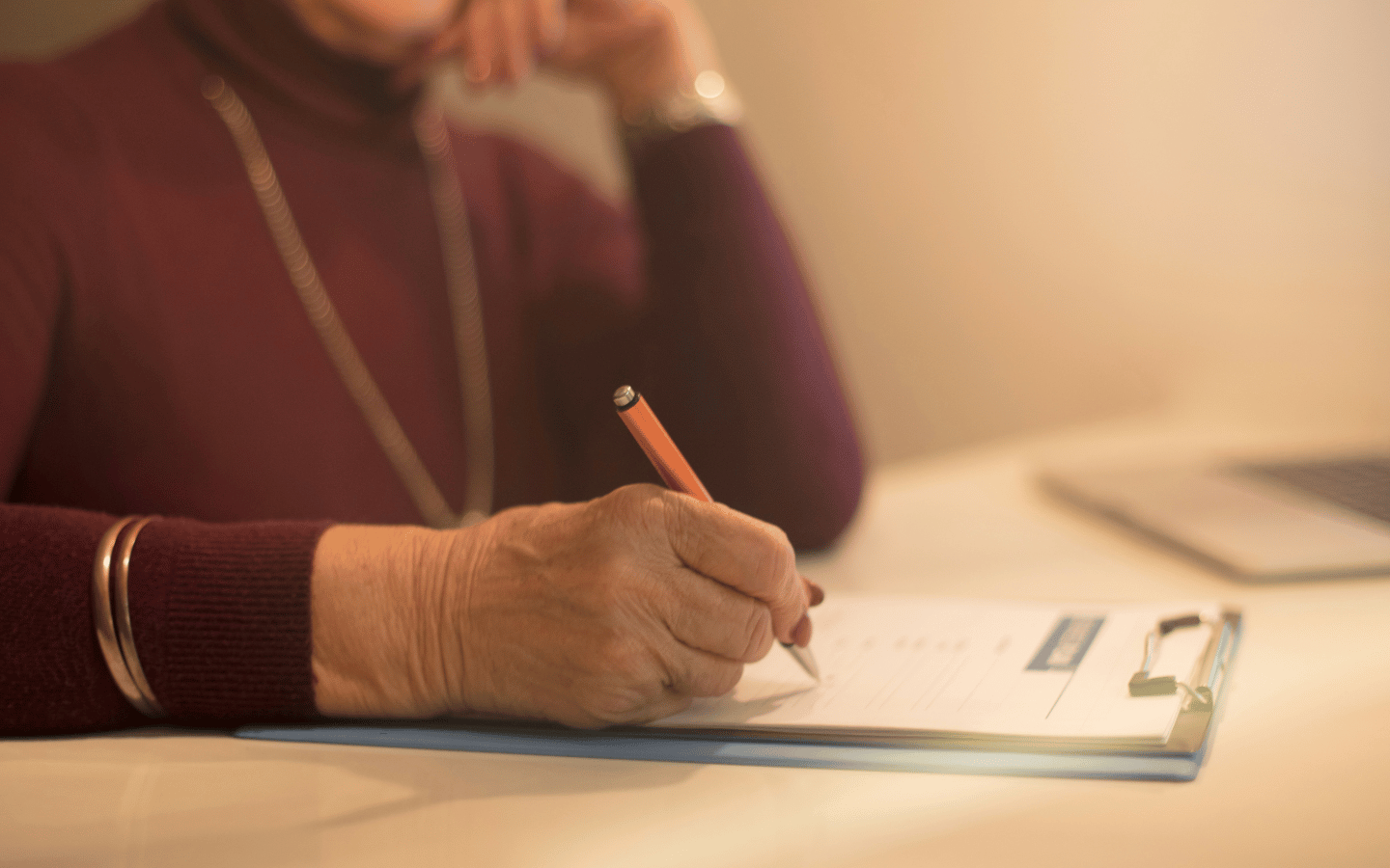 A lady signs a document.