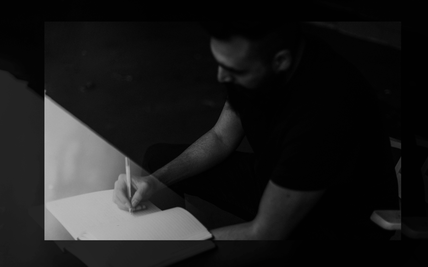 A man writes in a journal.