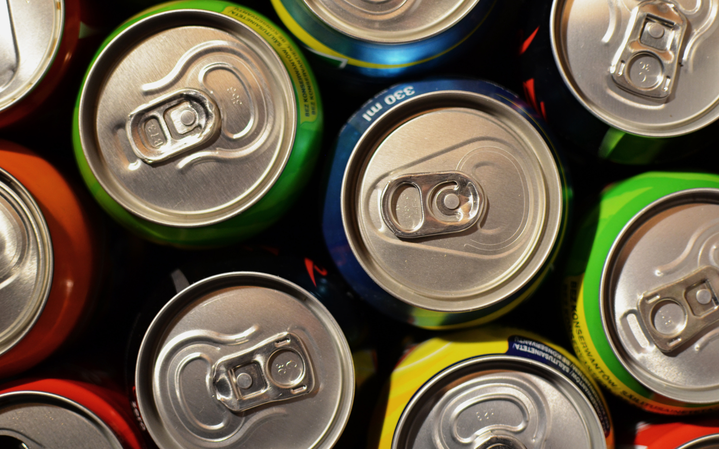 The tops of various soda cans.