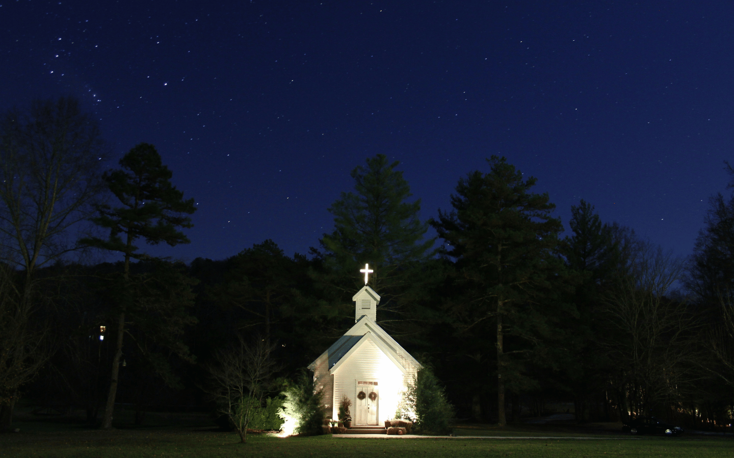 A country church building at night.