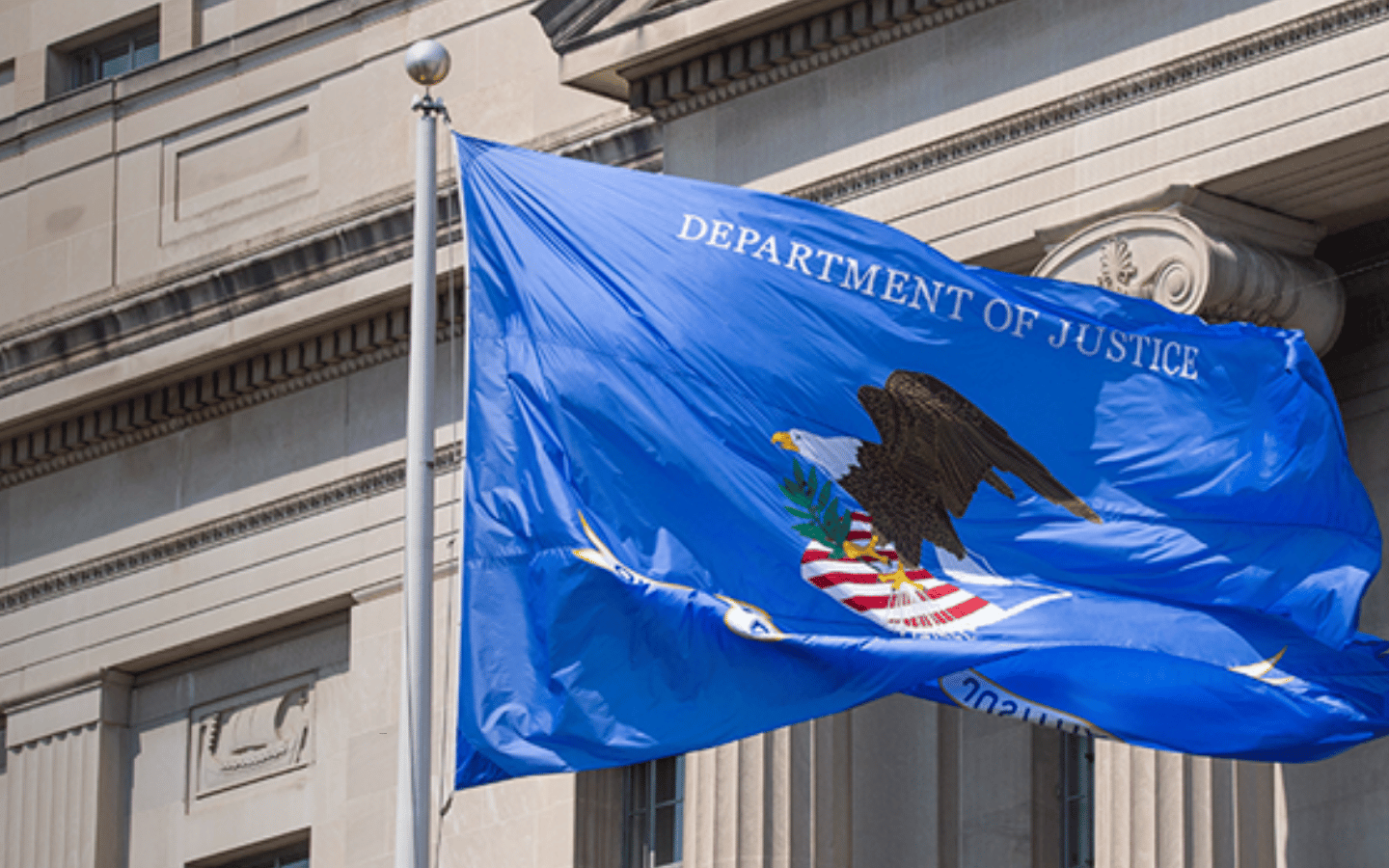 The flag of the Department of Justice flies in front of the DOJ building in Washington, D.C.