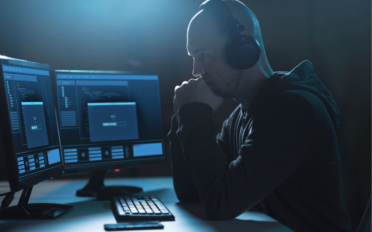 A spy listens to recordings on his computer.