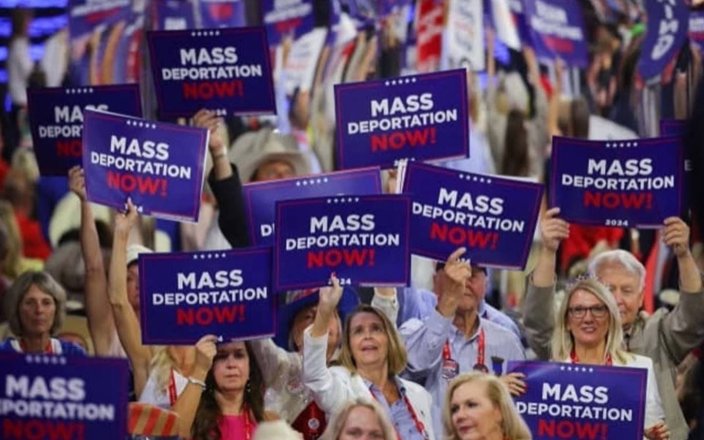 Delegates at the 2024 RNC hold up signs that read, “Mass Deportation Now.”