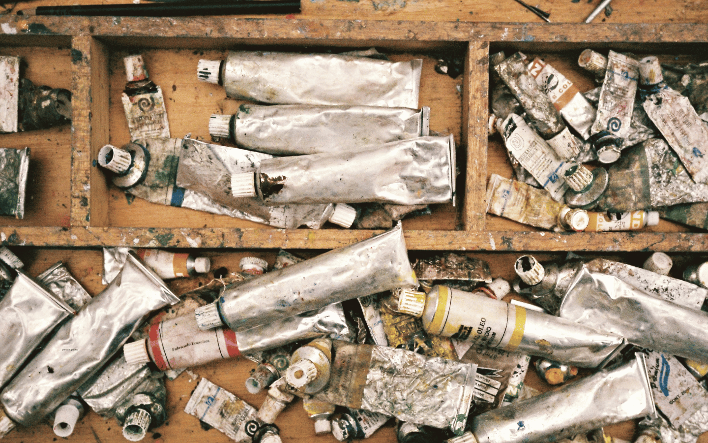 A drawer full of old paint tubes.