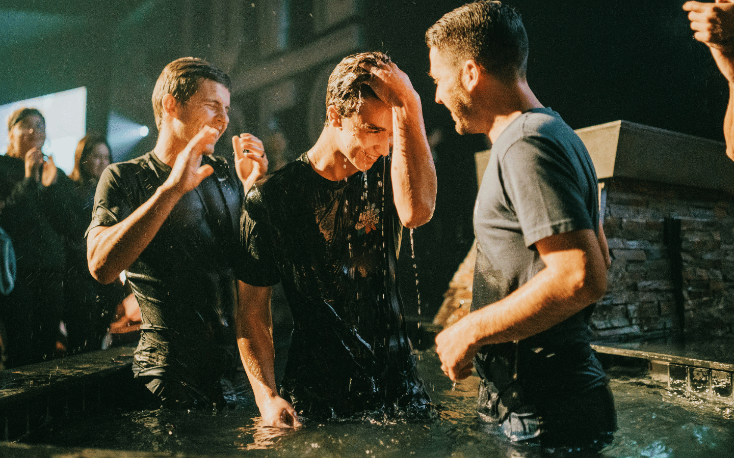 A young man is baptized at a church service.