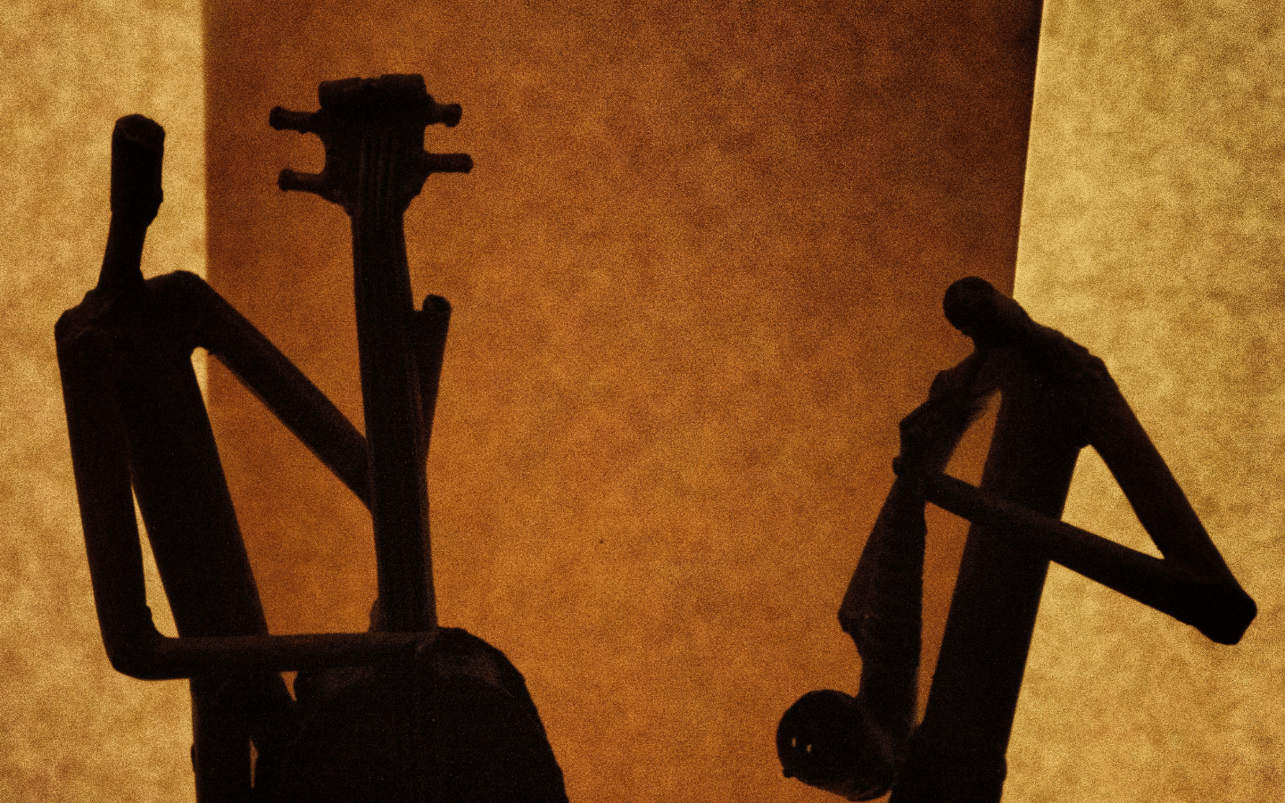 A graphic design of the silhouette of a jazz bassist and saxophonist.