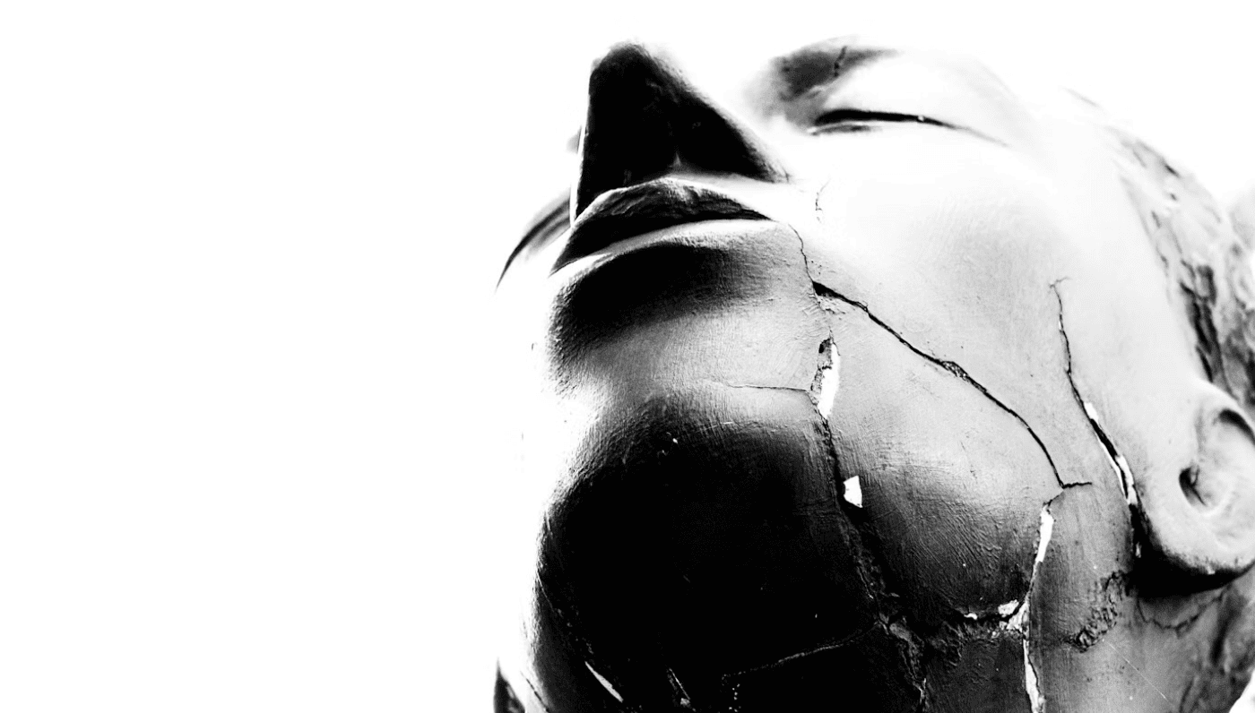 A cracked mask on a man’s face.