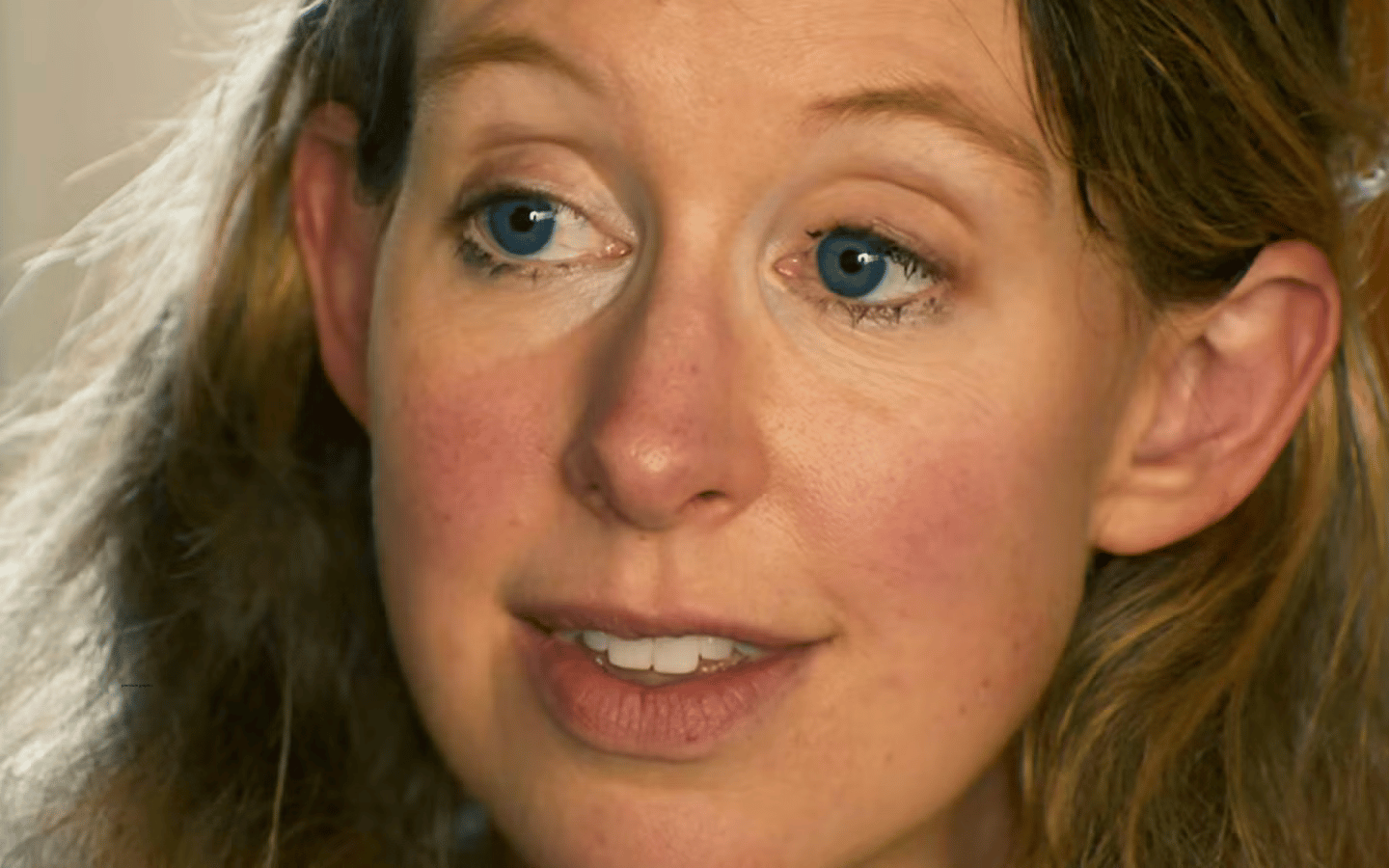 A close-up of Elizabeth Holmes’ face.